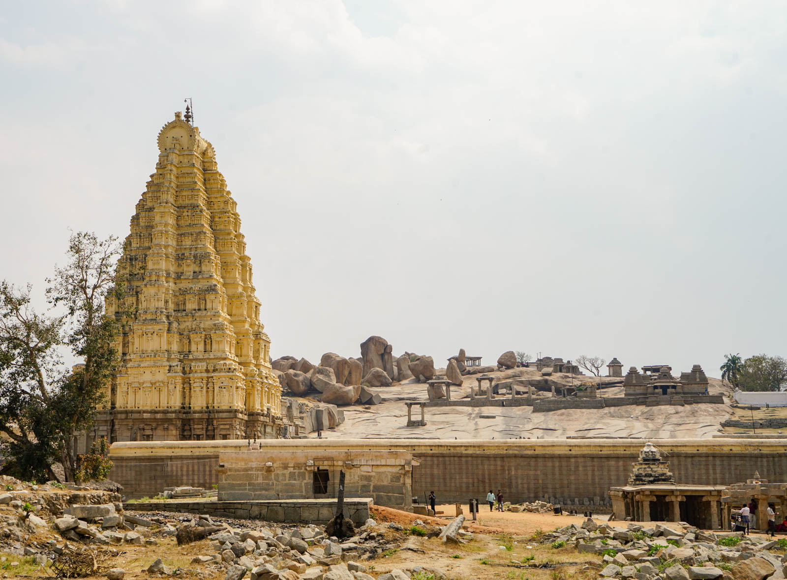 A temple still in use in the foreground with historic ruins in the background